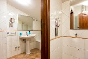 a bathroom with a sink and a mirror and a shower at Alghero Gilbert Ferret in Alghero