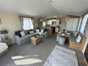 a living room with a couch and a table at Hot Tub 9 The Fairways in Alnwick