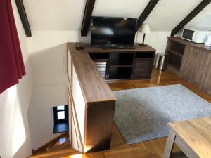 a living room with a wooden counter with a tv at Echo Apartman in Tihany