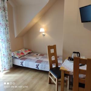 Ένα ή περισσότερα κρεβάτια σε δωμάτιο στο Willa Monika Zieleniec