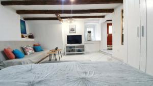 a bedroom with a bed and a living room at Studio Tony in Dubrovnik