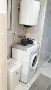 a bathroom with a washing machine and a toilet at Studio Tony in Dubrovnik