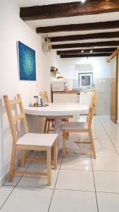 a dining room with a white table and chairs at Studio Tony in Dubrovnik