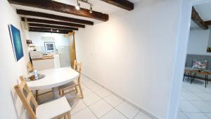 a kitchen and dining room with a white table and chairs at Studio Tony in Dubrovnik
