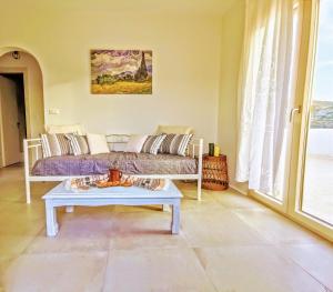 a living room with a couch and a table at Zeidoron Country Houses Naxos (Gaia House) in Káto Potamiá