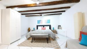 a bedroom with a bed in a room with white walls at Studio Tony in Dubrovnik