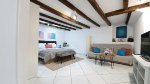 a bedroom with a bed and a couch at Studio Tony in Dubrovnik