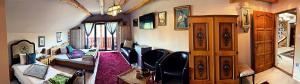 a room with a living room with a couch and a living room with a couch at La Curtea Veche in Lăpuş
