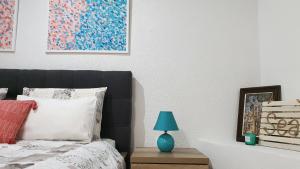 a bedroom with a bed with a blue lamp on a table at Studio Tony in Dubrovnik