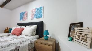 a bedroom with a bed with a blue lamp on a table at Studio Tony in Dubrovnik