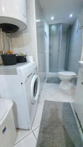 a bathroom with a washing machine and a toilet at Studio Tony in Dubrovnik +37 photos