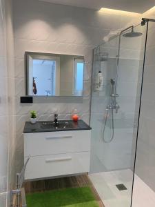 a white bathroom with a sink and a shower at Casa Raquel,caminito del Rey in Valle de Abdalagís