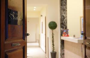 a hallway with a door and a potted plant at Hotel Sofia in Catania