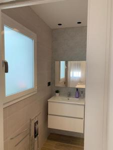 a bathroom with a sink and a mirror at Casa Raquel,caminito del Rey in Valle de Abdalagís