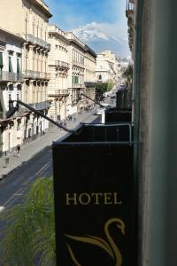 a hotel sign with a view of a city street at Hotel Sofia in Catania