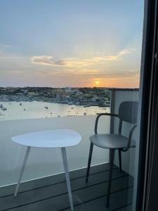 a table and chair on a balcony with a view at B&B Giro Di Boa in Lampedusa