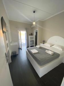 a bedroom with a large bed in a room at AEGEAN VIEW SEASIDE ROOMS AND STUDIOS KEA in Korissia