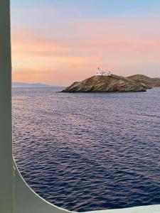 a house on an island in the middle of the water at AEGEAN VIEW SEASIDE ROOMS AND STUDIOS KEA in Korissia