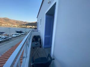 a balcony of a house with a view of the water at AEGEAN VIEW SEASIDE ROOMS AND STUDIOS KEA in Korissia