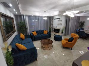 - un salon avec des canapés bleus et des chaises orange dans l'établissement Luxury Villa Sara in Malinska, à Sveti Ivan