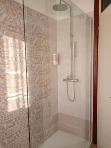 a shower stall with a glass shower door at La Cjase di Pieri e Vilme in Udine