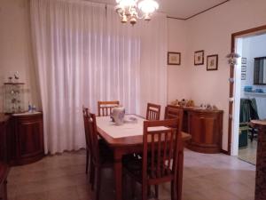 a dining room with a table and chairs at La Cjase di Pieri e Vilme in Udine