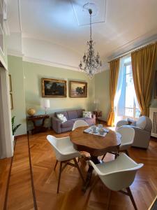 a living room with a table and chairs at Julius suite in Turin