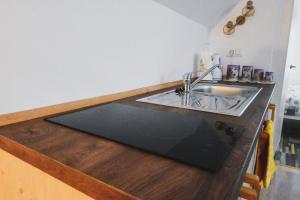 a kitchen with a sink and a counter top at Sobe - rooms R&K in Bohinj