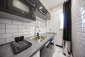 a kitchen with a sink and a counter top at NEAR EIFFEL TOWER - BEAUTiFUL FLAT in Paris