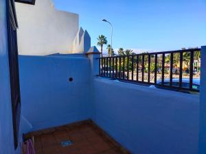 un balcón con una pared azul y una valla en va de Loft en La Laguna