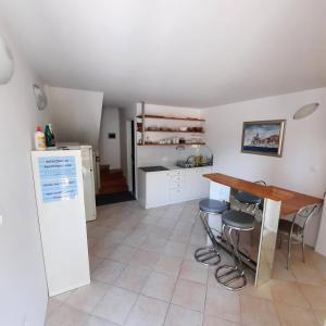 a kitchen with a table and stools in a room at Apartment Luka in Portorož
