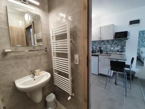 a bathroom with a sink and a toilet in it at Harmónia Panzió in Bogács +47 photos