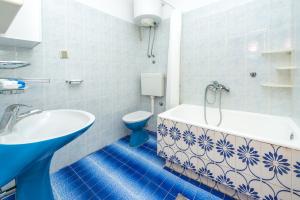 a bathroom with a tub and a toilet and a sink at Bace Apartments in Klek +109 photos