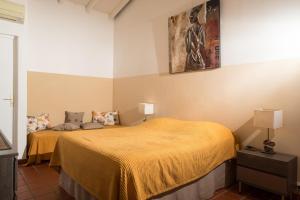 Postel nebo postele na pokoji v ubytování Hôtel Les Bananiers