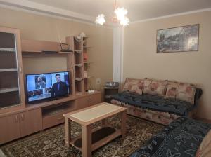 a living room with a couch and a flat screen tv at Sokobanja Apartmani in Soko Banja