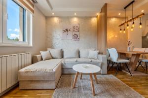 a living room with a couch and a table at Carpe Diem in Zlatibor