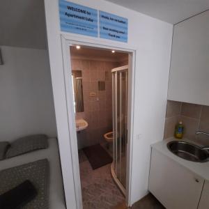 a bathroom with a sink and a toilet and a sign at Apartment Luka in Portorož +15 photos