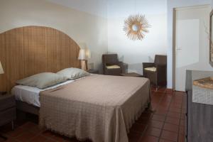 Postel nebo postele na pokoji v ubytování Hôtel Les Bananiers