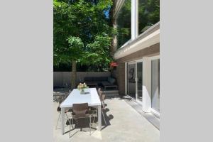 a patio with a white table and chairs at PARK Loft @ BRUGES with private (free) parking in Bruges