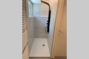 een badkamer met een douche en een glazen deur bij PARK Loft @ BRUGES with private (free) parking in Brugge
