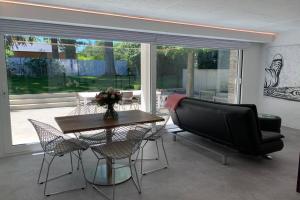 a living room with a couch and a table and chairs at PARK Loft @ BRUGES with private (free) parking in Bruges