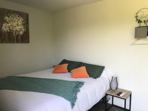 a bedroom with a bed with two pillows on it at Les gîtes de Belle Roche in Mâcon