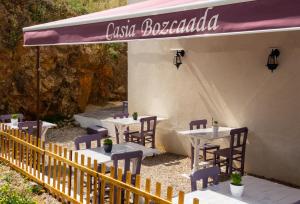 a restaurant with tables and chairs under a canopy at Mare Casia Bozcaada Otel in Bozcaada