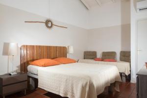 Postel nebo postele na pokoji v ubytování Hôtel Les Bananiers