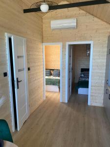a bedroom with two beds in a room with wooden walls at Domki Rozewie Holliday in Rozewie