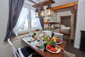 a kitchen with a table with fruits and vegetables on it at Ferienwohnungen Eifelstuben mit Charme - am See, nahe Burg in Ulmen
