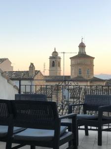 a group of benches sitting on top of a building at Residenza Aurea in Offida