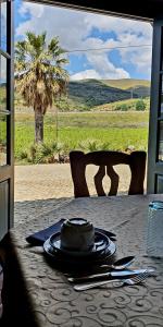 a table with a hat sitting on top at Quinta do Chao D'Ordem in Vila Nova de Foz Coa