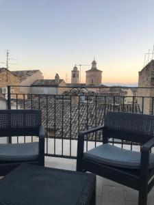 two benches sitting on top of a roof at Residenza Aurea in Offida