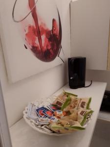 a plate of food on a table with a painting at Camera Noemi in Torre Lapillo